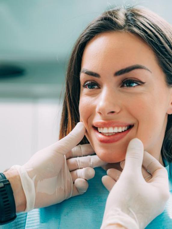 Dentist inspecting a patient’s smile