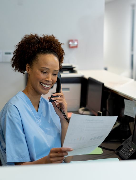 a woman on the phone with a dental patient