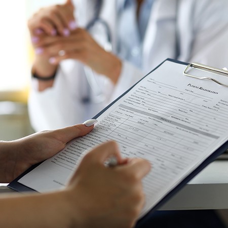 a patient filling out forms at the dental office