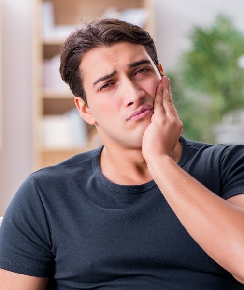 Man holding his jaw in pain