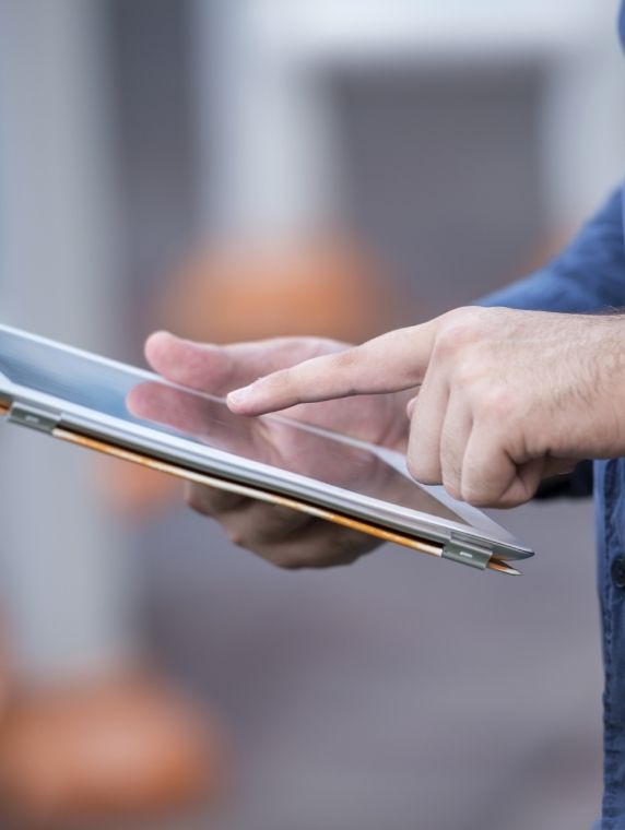 Person typing on a tablet