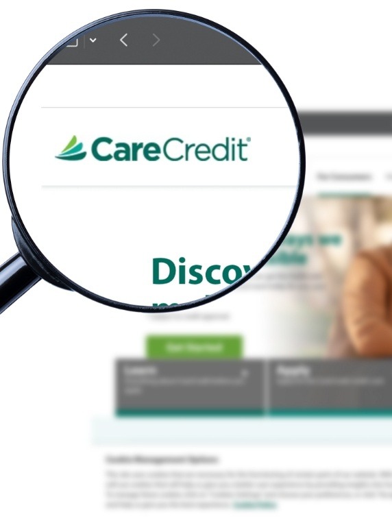 Magnifying glass showing Care Credit logo on their website