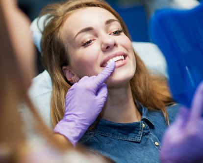 woman at dental office looking at her smile