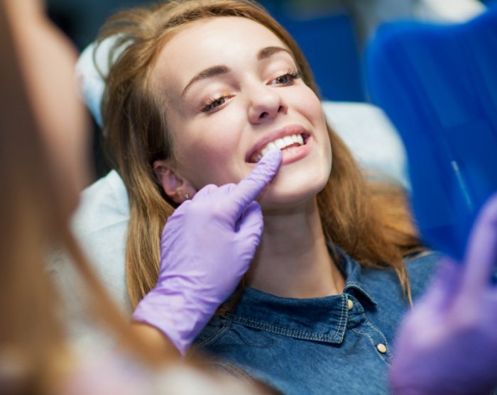 woman at dental office looking at her smile